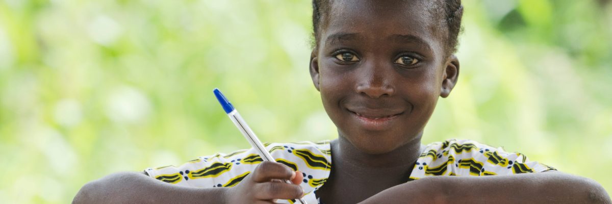 Young African Schoolgirl Writing Doing her Homework